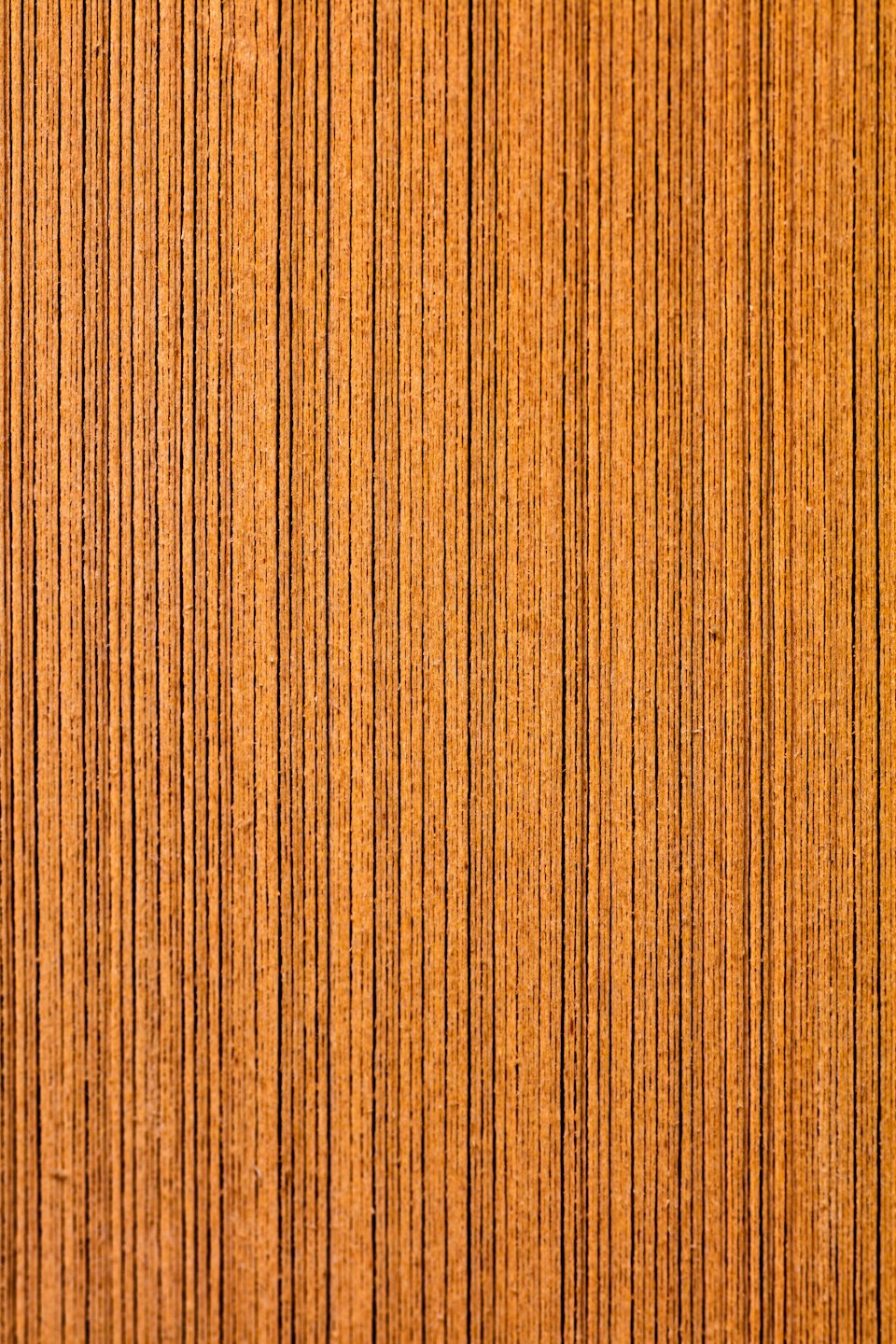 Light brown wood surface with vertical grain lines.