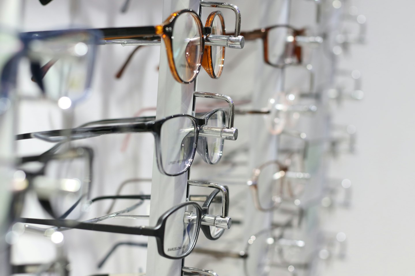 Eyeglasses frames displayed on a stand in a store.